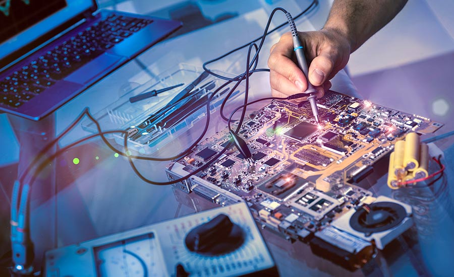 A man repairs a mother board in a service center