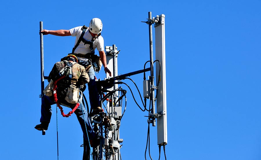 Technicians repairing a telecommunication tower